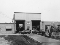 Further to my comment on Liam MacDougall's photo capturing a GO train at Danforth between Main Street and Victoria Park Avenue ( http://www.railpictures.ca/?attachment_id=42149 ), here is a glimpse of the CN Danforth Work Equipment Shop that once occupied the grounds where all the townhouses now sit. This photo was taken on the new shops official opening day of June 5, 1956. The new 'state of the art' facility replaced a much older and smaller facility on the same property. The old shop was built on a foundation that had the large rollup doors into the building at boxcar door/flatcar deck height. It became a small repair and storage facility when the new shop opened. After each season of rail replacement, tie replacement, ballast gangs, surfacing crews, and general Engineering projects, most equipment on the Great Lakes Region was returned to the Danforth shop to be repaired/overhauled for the next production season. Through the 1960's and 70's the yard tracks were home to the fleets of Engineering accommodation and work service cars including red fleet boarding cars, tool cars, coach cars, tanks cars, machinery flats, white fleet units, etc. They were all stored, stocked, and repaired here. With the ever increasing quantity, size and complexity of work equipment machinery, a new repair facility was constructed in Capreol, Ontario in the late 1970's to take some of the workload from the Danforth shops. The value of Toronto real estate made the railway property at the Danforth complex very appealing and the yard, Steel Bridge shop, and once modern Work Equipment shop would soon be gone to make way for the townhomes that are present there today.