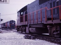 Prior to the start of GO Transit service in May 1967, GO's eight GP40TC units were "broken in" in CN freight service around southern Ontario. In this shot, unit 603 (wearing a CN logo) heads out of Aldershot Yard with an eastbound while the 606 leads a GP9 and RS-18 over the King Road crossing with a westbound freight.
