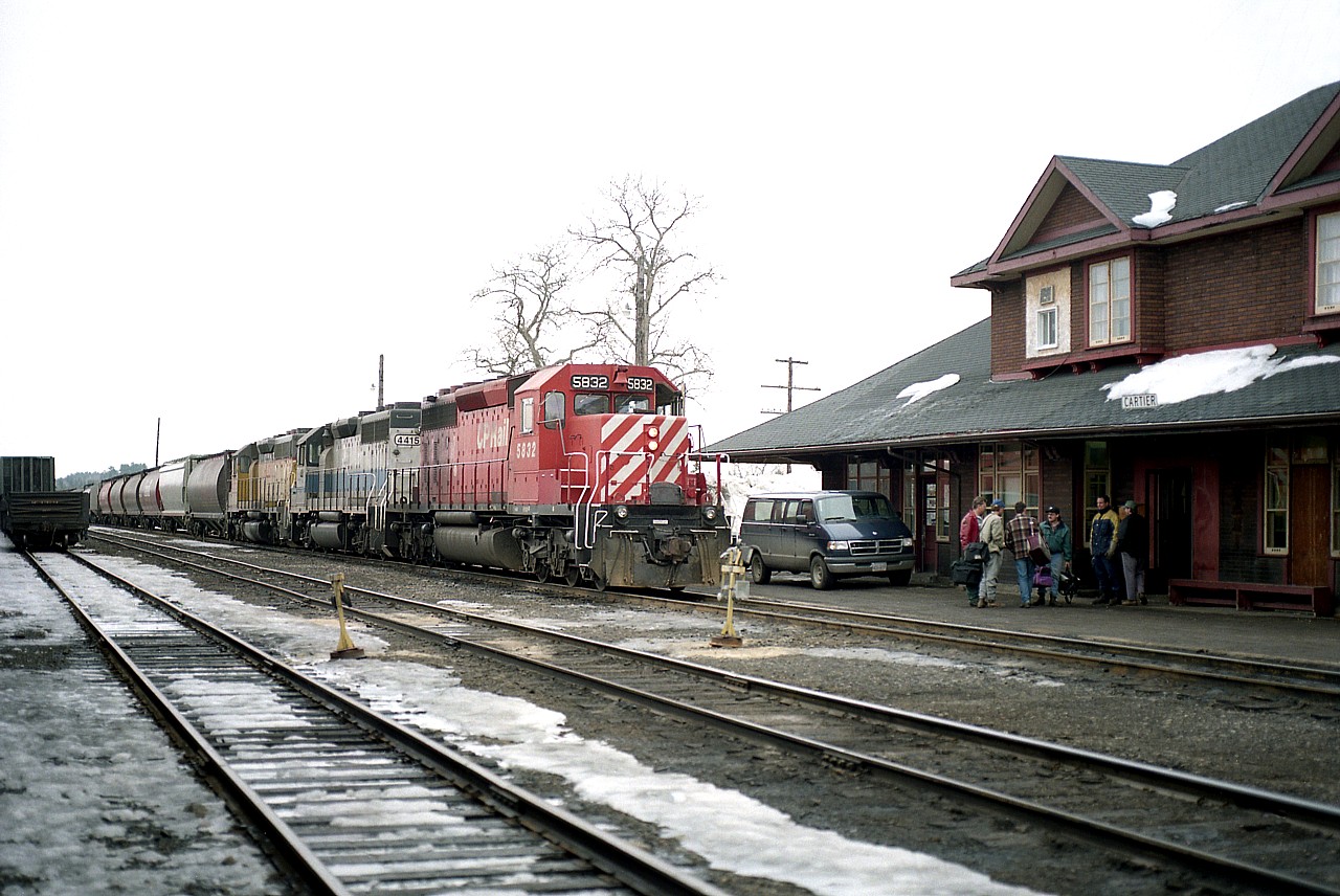 During crew change at the old CP Cartier station, a good gabfest is in the works as train #301 with CP 5832, HLCX 4415 and HLCX 3065 waits to head westward.  There were leased units abound during this time, as CP struggled with a huge power deficit. It is already April, but a lot of dirty snow still lingers, along with an equally grubby looking sky.
