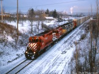 <b>VIA units pulling freight on the old TH&B:</b> During CP's lease-anything-that-runs era in the 90's, Reg Button was out on a cold February morning in 1995 to catch a rather odd lashup: CP SD40-2 5679 leading GP9u's 8239 and 8236, that are bracketing a pair of leased VIA F40PH-2 passenger units (VIA 6451 & 6449). They're seen at the head-end of CP train #526, cresting the climb up the Niagara Escarpment on CP's Hamilton Sub at Vinemount.
<br><br>
At one point amid all the rent-a-wrecks and lease units CP had running around the system, they had eight surplus VIA F40's running around in freight service, working all sorts of locals, turns, wayfreights and mainline trains with CP power (mostly in the Toronto/southern Ontario area, and the Windsor-Toronto-Montreal corridor).
<br><br>
<i>Reg Button photo, Dan Dell'Unto collection slide.</i>