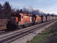 Three GP35s climb the Niagara Escarpment at Milton with a westbound in the spring of 1973.