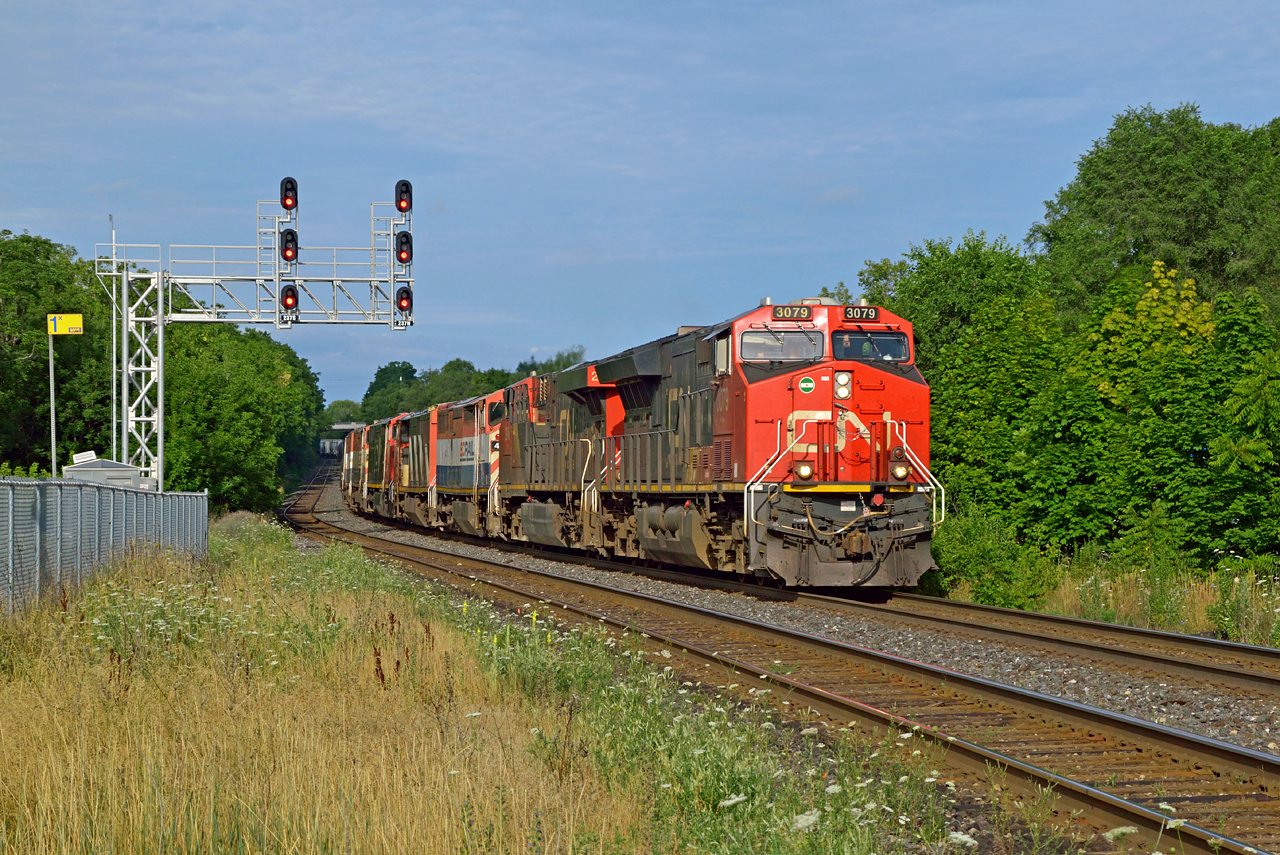 A nice surprise this morning, CN extra 382 nears it's final destination of Mac Yard passing through Georgetown at 0836h with 642 axles, plus a colourful assortment of 5 GE Dash 8-40CMs for K&K Recycling in Pickering.