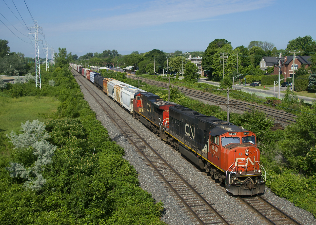 CN 322 has CN 5690, CN 2593 and 116 cars as it approaches MP 14 of CN's Kingston Sub on a sunny morning.