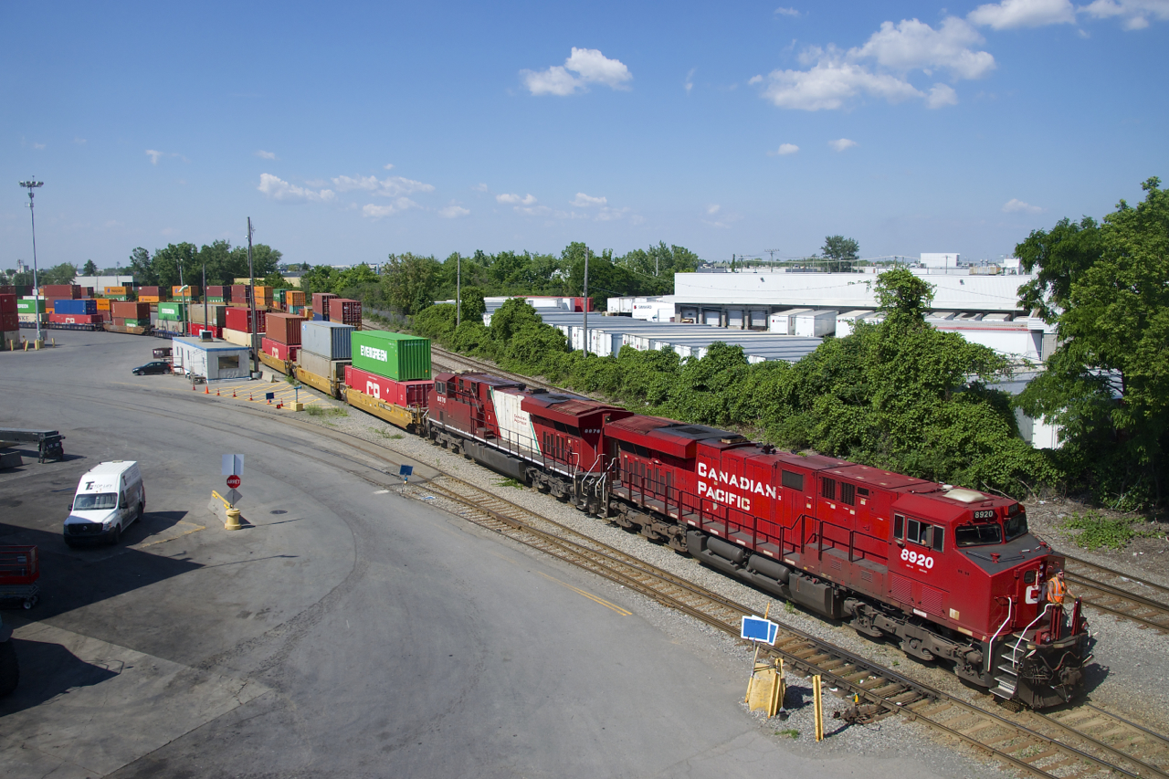 The last CP ES44AC to have part of its Olympic paint scheme intact (CP 8876) is trailing CP 8920 as CP 119 makes a lift at Lachine IMS Yard.