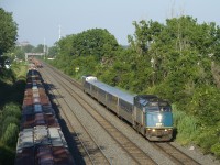 VIA 669 passes a cut of grain cars on a sunny evening.