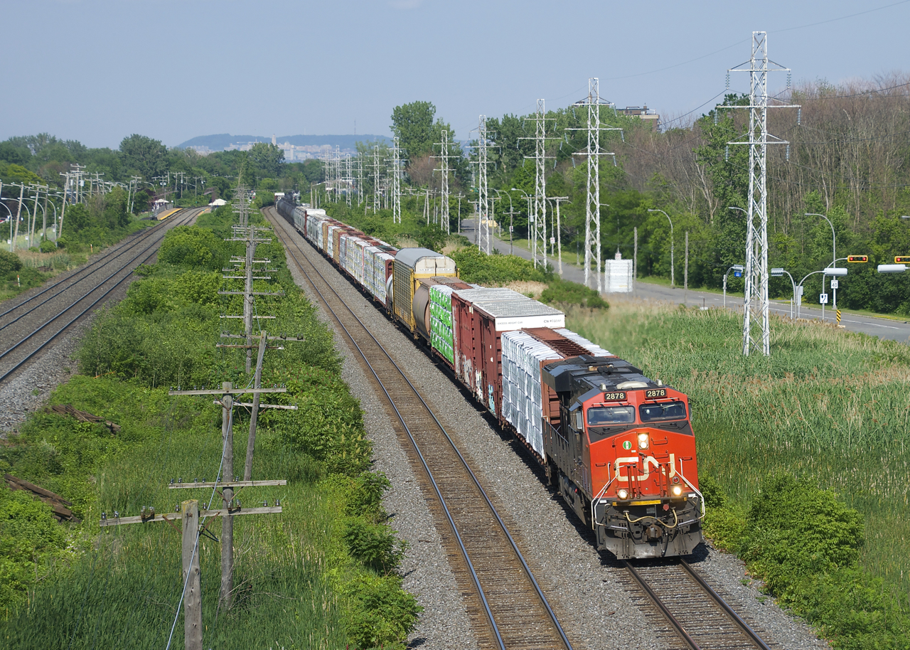 CN 377 with CN 2878 up front and CN 2849 mid-train heads west.