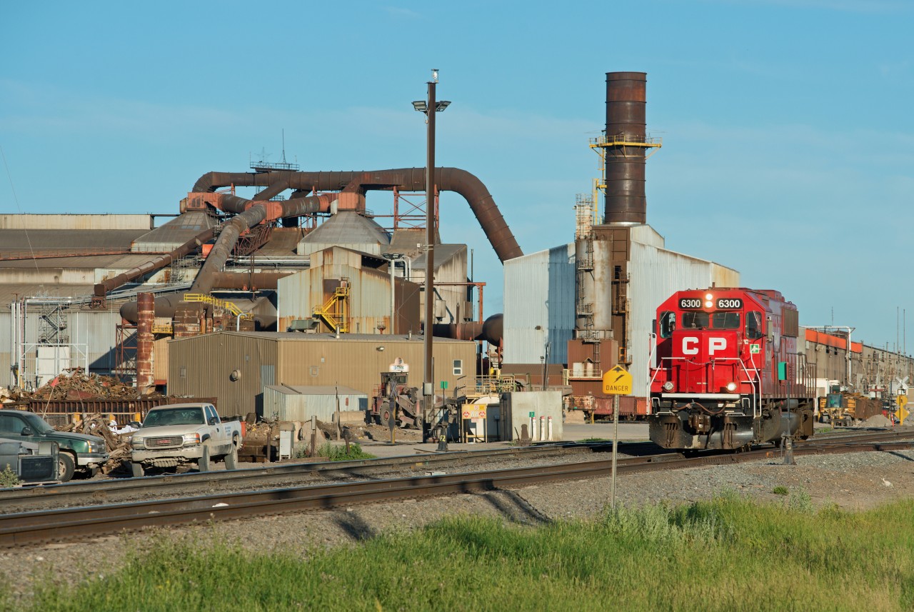 CP 6300 is seen passing the Evraz steel mill in the north end of Regina Saskatchewan. The 6300 is on its way to assist a southbound loaded potash train at Craven. There seems to be a small group of SD60s in captive service between Regina and Craven frequently referred to by the RTCs as "pushers", although I've yet to see one added anywhere but the headend.