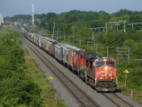 A 610-axle CN 106 heads east with grain up front, followed by the regular intermodal traffic. Power is CN 2238 and CN 2586 up front and CN 8964 mid-train.