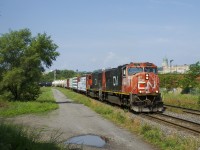 CN 324 with SD75I's CN 5737 and CN 5760 and 72 cars rounds a curve, on its way to St. Albans and interchange with the NECR.