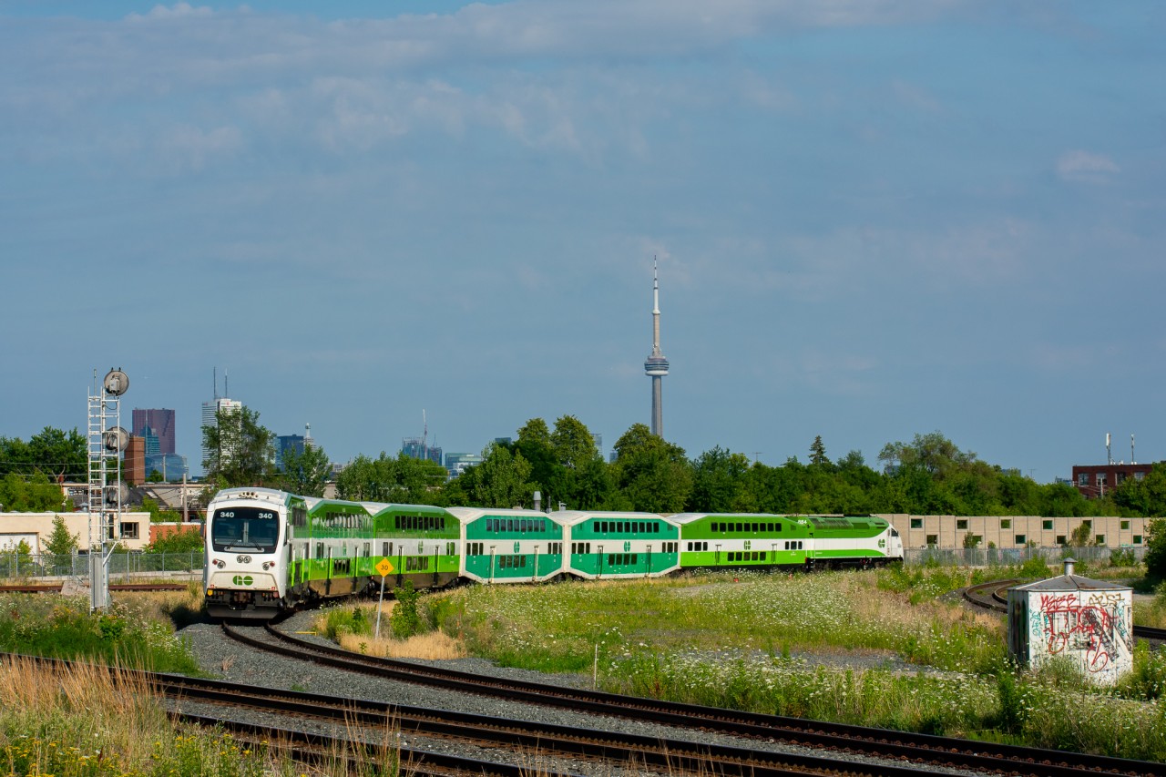 GO CEM cab car 340 leads an afternoon Milton line train through the curve at West Toronto. This shot is a bit of a rare sight as the track the GO is using in this image is normally only utilized by CP trains working the east end of Lambton Yard who use it for headroom. This day however, track work was happening on the track GO normally uses (seen on the right side of the image) so they were forced onto the second track. It made foe a much nicer shot as I was able to get the entire train in the frame as well as the CN Tower.