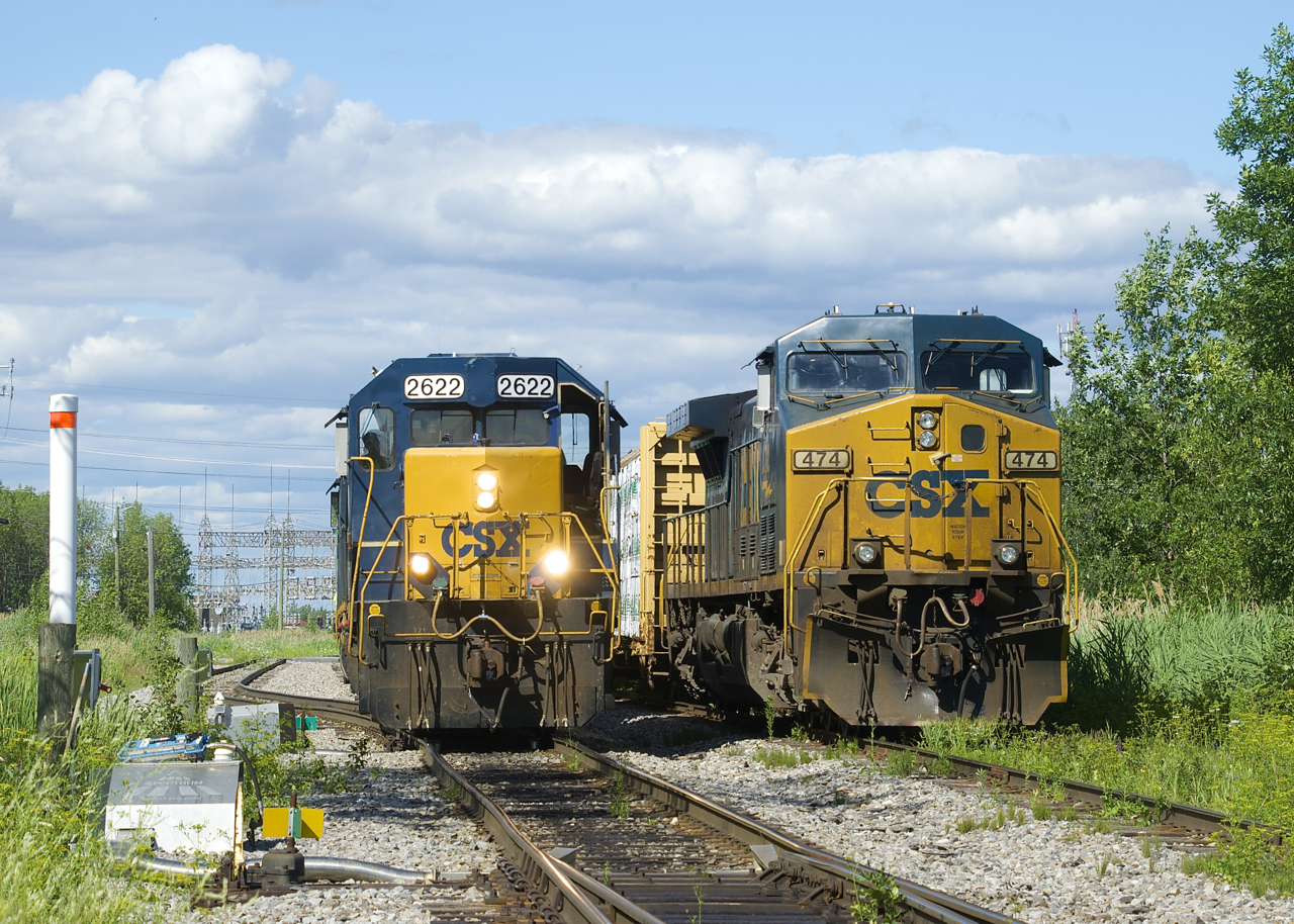 CSXT B786 at left is backing up with a single hopper to put onto its train before departing Beauharnois. At right is CSXT 474, which was power on CSXT B762 from Massena.