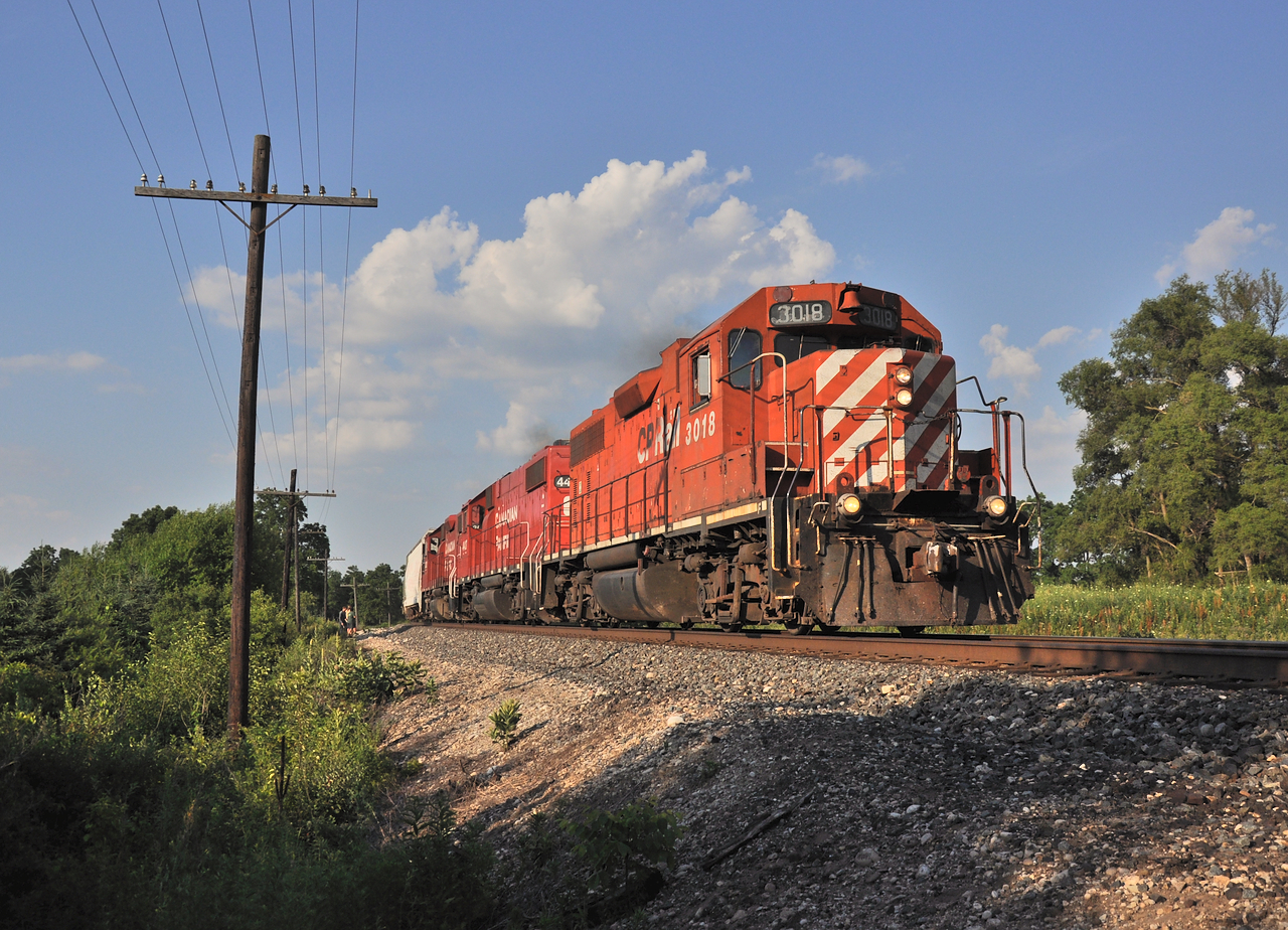 T69 screams East after making a large lift in Guelph Junction with roughly 25/30 hoppers in tow.