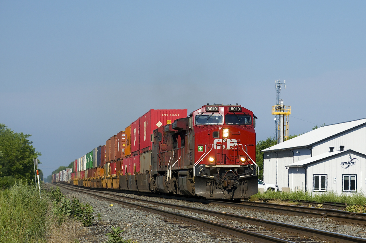 A short CP 119 races through the town of St-Clet with CP 8019 & CP 8610 for power. At right a feed mill stood until it was demolished two years ago.