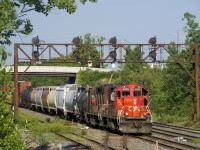 After waiting for an eastbound to leave Taschereau Yard, CN 596 with traffic from the Port of Montreal is about to enter the yard with GP9's CN 7075 & CN 4141 for power.