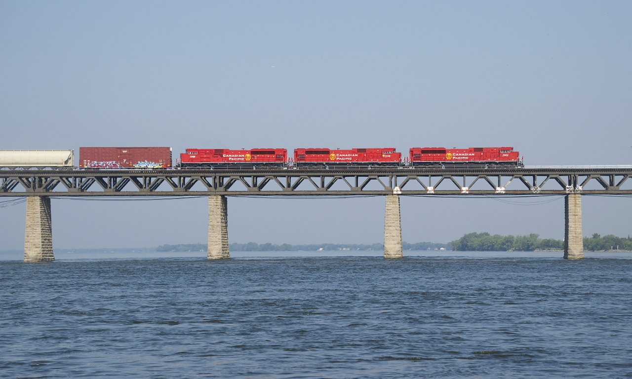 A trio of fresh SD70ACU's (CP 7054, CP 7045 & CP 7055) lead a 140-car CP 253 over the St. Lawrence River. They had been delayed a bit south of here when a hotbox detector on CP's Lacolle Sub warned them of a problem.