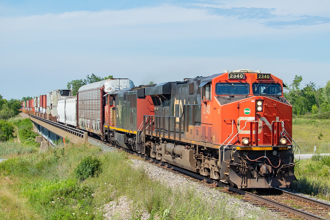 After being cancelled for two or three months, 531 recently returned to service, and is pictured here at CN Yager on its way to Fort Erie and Buffalo. The head end three cars are for the NS for interchange in Fort Erie, the containers are for CSX in Buffalo (with 539 handling other CSX-bound traffic), and behind the stacks was traffic for the BPRR in Buffalo. In 531's absence, 562 was handling the interchange duties, and extras were common as well. Power for this day was 2340 and 2444.