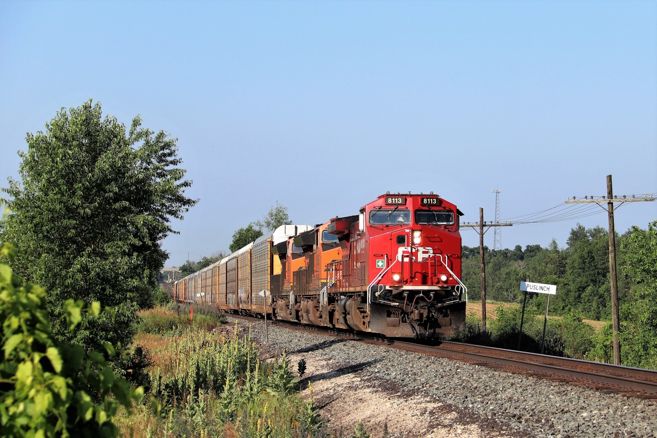 Not a bad morning, Getting two CP eastbounds in 30 minutes in near perfect sun is always good! CP 234 was about as blah as one could get, then I heard a clearance for 8113 east to Guelph Junction. Rumbling up the grade it comes with two BNSF pumpkins in tow.  CP 8113 with BNSF 3905 and BNSF 3952 are making good time as they pass the Puslinch mile board on their was for a stop at Hornby.