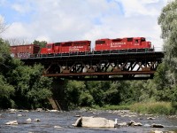 This is honestly a spot I often overlook, especially at this time of year. Usually I figure it is too hot for the brief hike in and it is often very overgrown and bug infested here in the summer, but my boys have been bothering me a lot lately to try this shot and today seeing that T14 was ready to depart the yard and had nothing special for power made the decision easy to go for scenery rather then just the train. While it was not too overgrown getting in, the countless ant bites almost made us run back to the car. Luckily the 15 minute wait proved worth it as T14 soared above with 3 cars off the branch destined for Toronto. It almost appears like the seagull hiding behind the rock was enjoying to he show of us constantly flicking ants into the air, LOL. There is a lot of history in the Credit River Valley here in Streetsville, and a dam once blocked the river behind me flooding where I am standing. The purpose was for the dam to power the ADM mill also located behind me. Of course years ago the mill switch from water power to electricity making the dam unnecessary. It was then demolished, although some ruins remain. 
