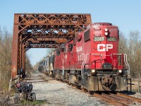 On rails typically only graced at night, TE11 is pictured here on a nice spring afternoon crossing over the Welland River on its way back to Welland with cars from Chemtrade and Washington Mills. A little over a year ago, Arnold Mooney shared <a href="http://www.railpictures.ca/?attachment_id=36718" target="_blank">a glimpse of this scene</a> from 1991, when it was double tracked, with westbound train 321 crossing the bridge with CSXT 8221 and 6218. It's still pretty easy to picture it as a mainline to be honest. As far as branchlines go, the track and roadbed appear to be in decent shape in most places, but nonetheless they trundle along at no more than 10 mph. <br><br>Before anyone asks, this move is done by TE21 at night on the Wednesday and Saturday overnight shifts. In other words, this is not the norm.