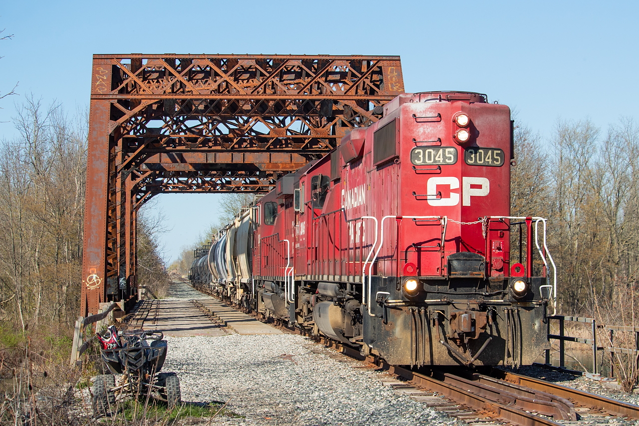 On rails typically only graced at night, TE11 is pictured here on a nice spring afternoon crossing over the Welland River on its way back to Welland with cars from Chemtrade and Washington Mills. A little over a year ago, Arnold Mooney shared a glimpse of this scene from 1991, when it was double tracked, with westbound train 321 crossing the bridge with CSXT 8221 and 6218. It's still pretty easy to picture it as a mainline to be honest. As far as branchlines go, the track and roadbed appear to be in decent shape in most places, but nonetheless they trundle along at no more than 10 mph. Before anyone asks, this move is done by TE21 at night on the Wednesday and Saturday overnight shifts. In other words, this is not the norm.