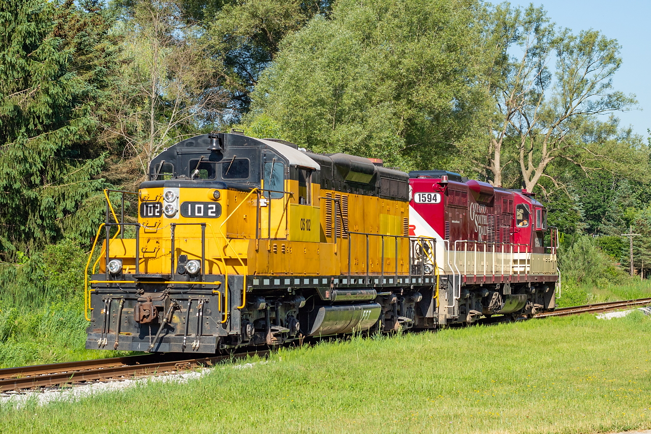 Former ETR 102 and now OS 102 (and the last GP9 ever built) made its first revenue run for the Ontario Southland today on the St. Thomas Job. The morning lighting on the St. Thomas Sub is less than stellar this time of year, so the northbound run on the Port Burwell will have to suffice for now. Hardly anyone was out for it at first, but then word got out on Facebook and quite a few fans were out by the time it got to St. Thomas, probably leaving the locals scratching their heads as to what the fuss was all about.