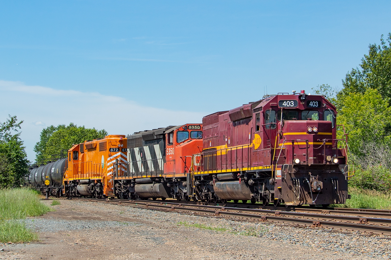 Thunder Bay's CN Yard power has quite the eclectic lashup - with DMIR 403, CN 5350, and EJE 672. They're pictured here in Fort William, with cars in tow for McAsphalt.