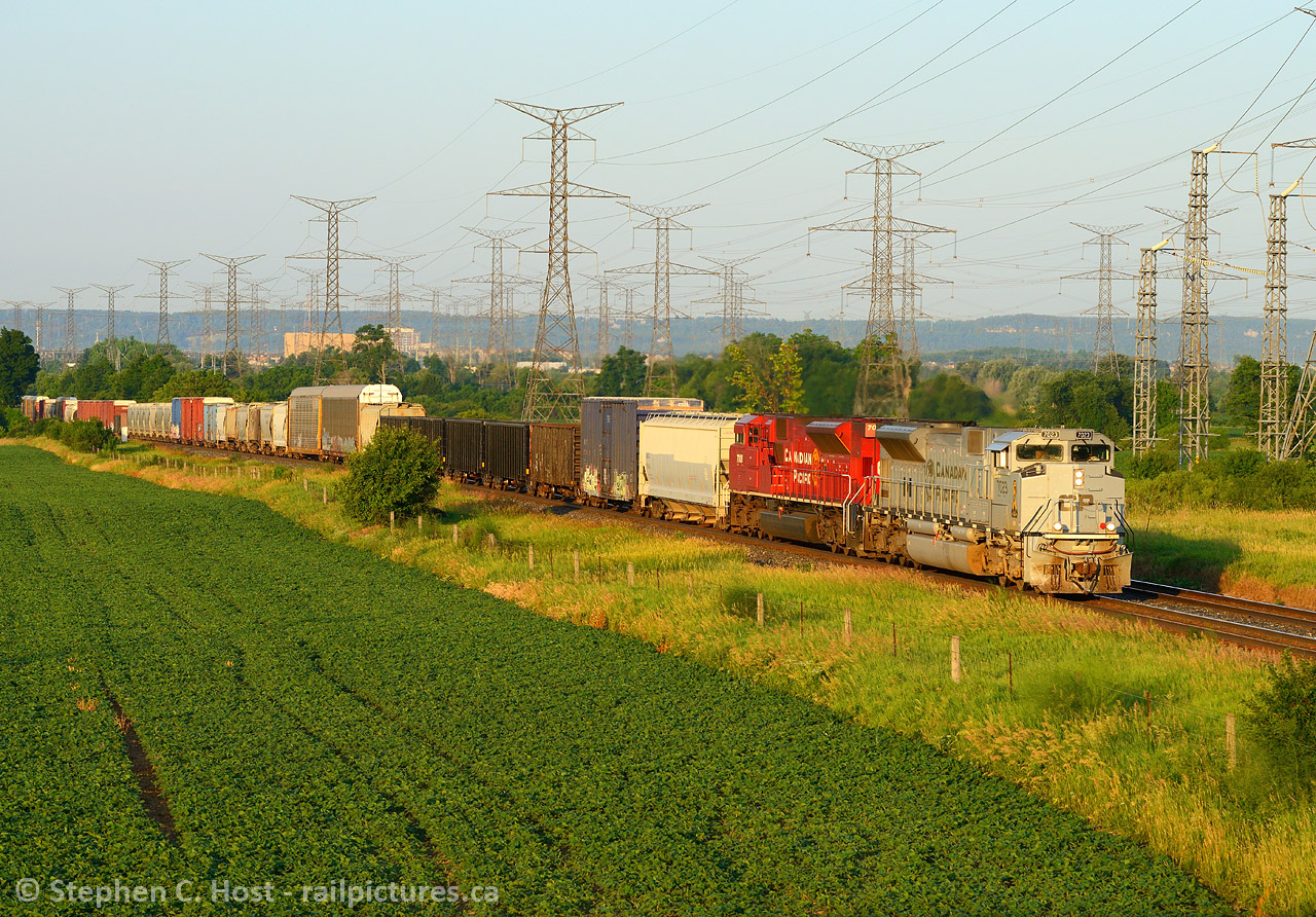 Who's koo koo crazy to get up at 0530 to shoot a train here at some ungodly morning hour? Me. The sun has barely had 20 minutes to warm the ground and I am standing on the side of the Trafalgar rd overpass to get under the wires and the time is 0638. Years ago we had a grade crossing at Trafalgar and I shot  CP's Business train  but from ground level. But why did I put the sleepless effort into this? Truth is a few days ago during my 2 week vacation I got up early to shoot 7023 leading a 234  and it ended up not leading.. so this is redemption and why I had to get up early - now I can strike this military unit off my TODO list and strike the thought of getting up early for it next time it happens, I much prefer a little more sleep in my life :) At least the light is as good as it gets!