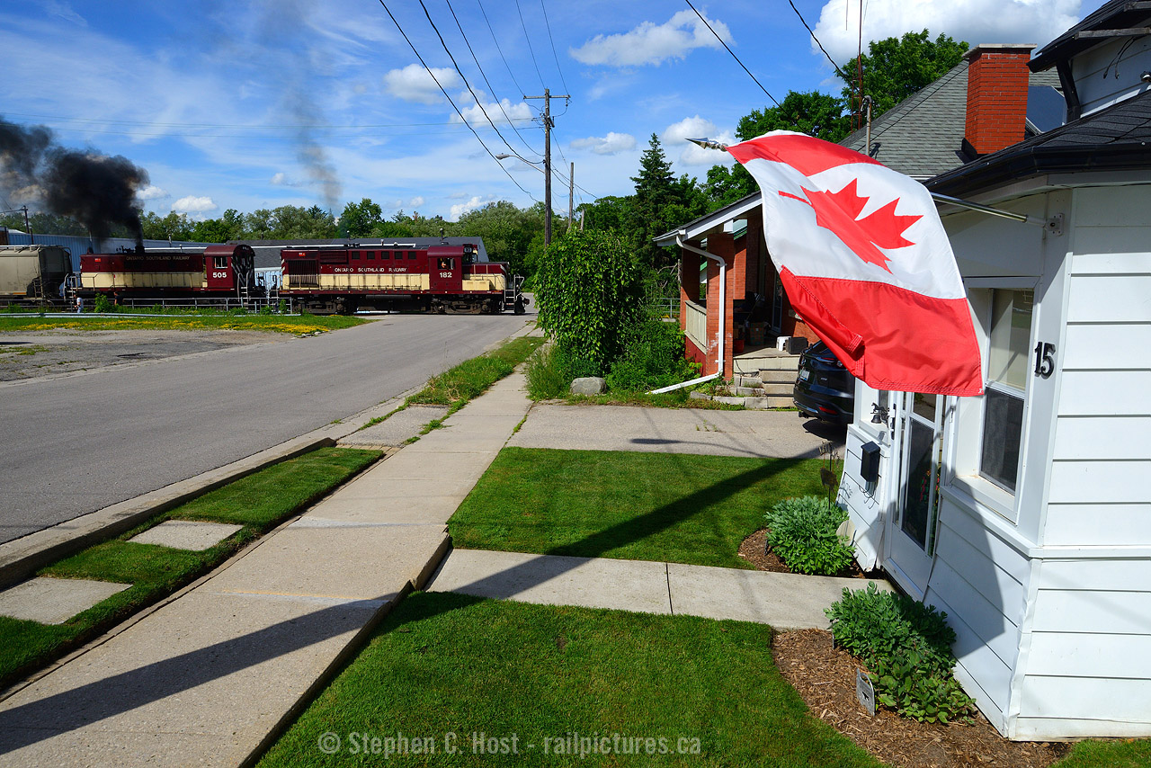While we can't enjoy the many fireworks this year, perhaps a little alco smoke will tide us over. Engr. Snook is heavy on the throttle as Ontario Southland is heading back toward home after a day of switching in the north end of Guelph, with a little alco smoke passing some of our town's Patriotism.  Happy Canada Day everyone!