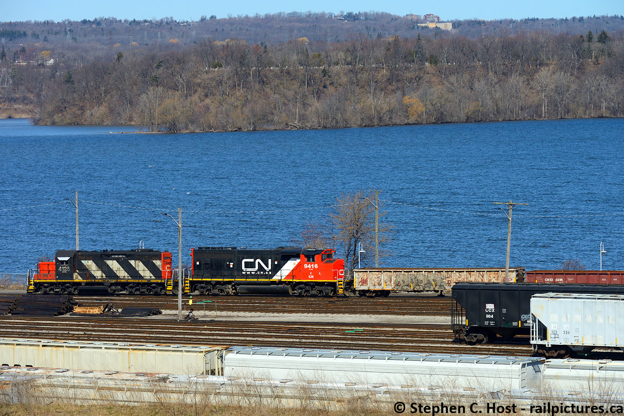 By the water, CN's 0800 yard job is seen drilling the west end of the yard in Hamilton with Burlington Bay / Lake Ontario in the background.