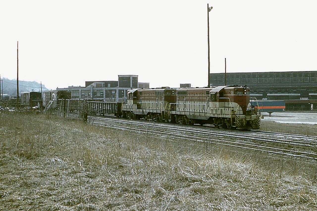 When I looked at this shot, it reminded me of how "some days are like this".  A hazy nondescript sky, everything a monotonous brown. The sky, the foreground and even the locomotives.  Not much to break up the colours of this image. The scene is of TH&B 71 and 74  with a local heading out of the Aberdeen facility, destination unknown, or rather, forgotten.