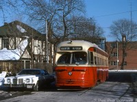 TTC 4560 (an A-9 class PCC streetcar, part of a group of 1947-built cars that the TTC acquired secondhand from Cincinnati in 1950) is seen operating on a fantrip, posed on Hillside Wye for a photo op. New CLRV streetcar deliveries were on the horizon, and that meant retirement for much of the TTC's secondhand PCC fleet. Despite this, the old car had been given a thorough spit-and-polish cleaning by shop forces prior to its outing (note the lack of typical winter road grime buildup).
<br><br>
The Hillside Wye was a short on-street wye located on Hillside Avenue north of Lakeshore Blvd W. in Mimico, according to <a href=https://transittoronto.ca/spare/0017.shtml><b>Transit Toronto</b></a> first coming into existence in 1928 after a reconstruction of the old Toronto & Mimico radial railway line for the city's Lake Shore streetcar service. It managed to survive (although very rarely used) until removal in 2002. The Mount Pleasant route exposure (destination Eglinton loop) is a little out of place for Mimico, but the exposures for the short-lived Mount Pleasant route were still in the roller blinds and might have made for a neat photo here.
<br><br>
The 1970's Pontiac Grand Prix parked curbside sports some original A-series license plates (AOU 381 in this case), first dating from 1973 when Ontario switched to the fixed ownership license plate system still in use today (the plates didn't have to be replaced yearly like years prior, and were tied to the owner of the vehicle).
<br><br>
<i>Robert McMann photo, Dan Dell'Unto collection slide</i>.