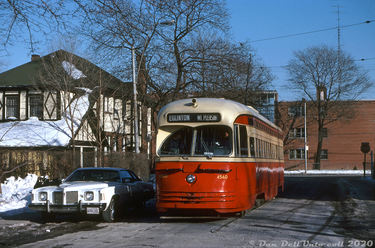 TTC 4560 (an A-9 class PCC streetcar, part of a group of 1947-built cars that the TTC acquired secondhand from Cincinnati in 1950) is seen operating on a fantrip, posed on Hillside Wye for a photo op. New CLRV streetcar deliveries were on the horizon, and that meant retirement for much of the TTC's secondhand PCC fleet. Despite this, the old car had been given a thorough spit-and-polish cleaning by shop forces prior to its outing (note the lack of typical winter road grime buildup).

The Hillside Wye was a short on-street wye located on Hillside Avenue north of Lakeshore Blvd W. in Mimico, according to Transit Toronto first coming into existence in 1928 after a reconstruction of the old Toronto & Mimico radial railway line for the city's Lake Shore streetcar service. It managed to survive (although very rarely used) until removal in 2002. The Mount Pleasant route exposure (destination Eglinton loop) is a little out of place for Mimico, but the exposures for the short-lived Mount Pleasant route were still in the roller blinds and might have made for a neat photo here.

The 1970's Pontiac Grand Prix parked curbside sports some original A-series license plates (AOU 381 in this case), first dating from 1973 when Ontario switched to the fixed ownership license plate system still in use today (the plates didn't have to be replaced yearly like years prior, and were tied to the owner of the vehicle).

Robert McMann photo, Dan Dell'Unto collection slide.
