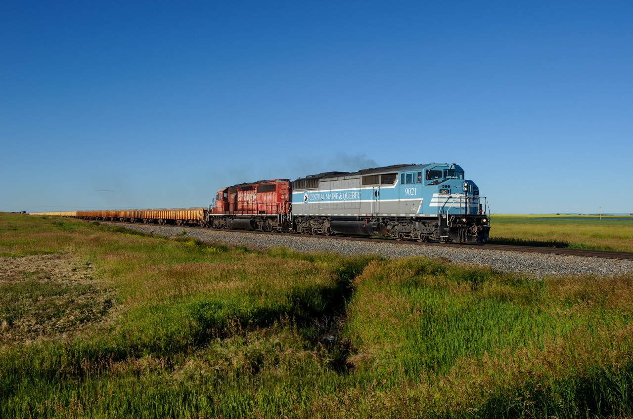 A long way from "home", CMQ SD40-2F 9021 leads a loaded ballast train north towards Calgary on CP's Aldersyde Sub.