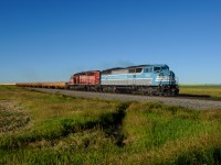 A long way from "home", CMQ SD40-2F 9021 leads a loaded ballast train north towards Calgary on CP's Aldersyde Sub.