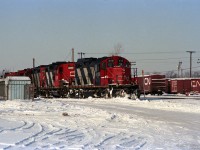 CN 4113 is a GP9 remanufactured at Pointe St-Charles in Montreal; short hood chopped becoming front end, etc. <br><br>
Behind it are an as-built GP9 CN 4385, GP9rm CN 4129, an SW1200RS, and yard GP9rm CN 7034.<br><br>
At the left can be seen CN Dundas sub signal 765N.<br>
On the right side are some double-door boxcars, including CN 73421 (re-numbered for non-revenue service).<br><br>
Submitted during a summer heat wave in Ontario, inspired by the question: "Why can't it snow in July when we need it?"  

   