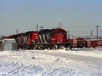 CN 4113 is a GP9 remanufactured at Pointe St-Charles in Montreal; short hood chopped becoming front end, etc. <br><br>
Behind it are an as-built GP9 CN 4385, GP9rm CN 4129, an SW1200RS, and yard GP9rm CN 7034.<br><br>
At the left can be seen CN Dundas sub signal 765N.<br>
On the right side are some double-door boxcars, including CN 73421 (re-numbered for non-revenue service).<br><br>
Submitted during a summer heat wave in Ontario, inspired by the question: "Why can't it snow in July when we need it?"  

   