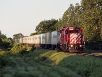 GP38-2 CP 3046 is moving its train of approximately 20 Triple Crown trailers through the countryside outside of London Ontario.<br>
The sun is low in the sky, so either a morning eastbound, or an evening westbound.<br><br>
A single GP38-2 powered Triple Crown trains in a number of John Parnell photos from the first half of the 1990's.<br>
Submitted exactly 29 years to the day since the image was taken.