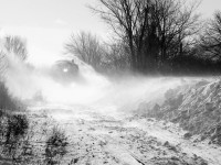 OSRX 175 - OSRX 6508 disappear into a cloud of snow, after making their first pass with the plow at Daniel Road