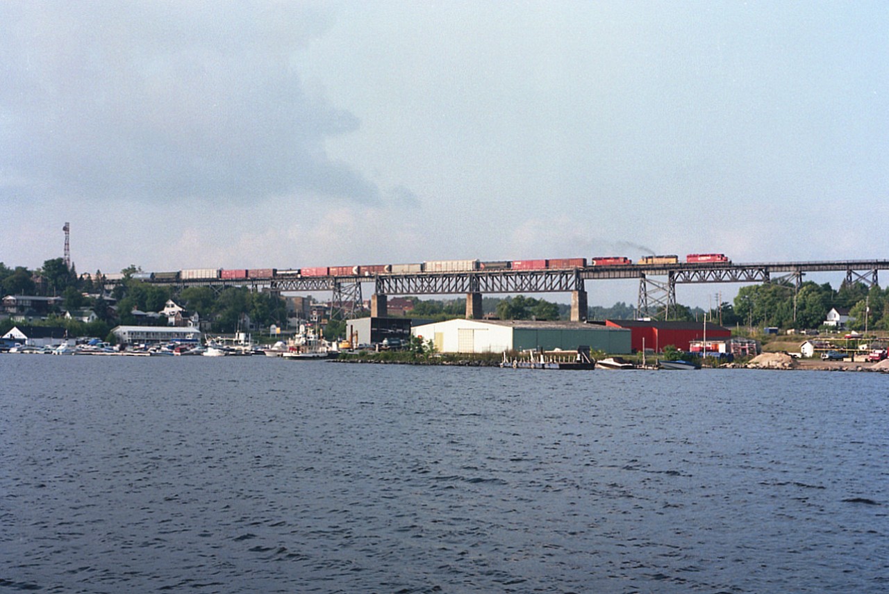 There are a lot of Parry Sound bridge pictures out there. But unless you have actually been there, it is hard to image by photo how big this trestle really is. It spans 1697 ft crossing the Seguin River, and most of the structure is visible in this shot taken from quite a ways out. The 1908-built landmark is impressive indeed.  On this day, it is getting close to sundown as CP 5549, HLCX 3066, and CP 5694 as train #474 thunder southward en route to Toronto. 
These days, this is part of a shared asset zone, with trains CP and CN running only northward here; and running southbound over the CN line which wanders thru the downtown.
