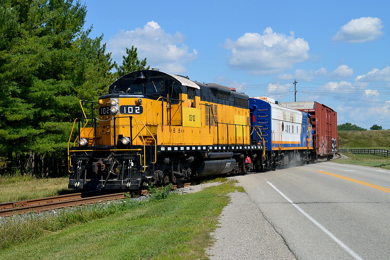 The former Essex Terminal #102, now on OSR, is out for what I believe is only its third run with it's new owners, on a beautiful Friday afternoon. It is shown here crossing Putnam Rd heading down toward St. Thomas. The F unit is #1400 and there is only one car in tow.  In the background you can see the Hwy 401 overpass.