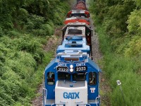 A friendly wave from the brakeman on 580 as the train crawls towards Brantford's east end and ducks under Wayne Gretzky Parkway. Up front are a pair of GP38's and a Dash-9, and pulling hard on the trailing units draw bar is a long cut of coil cars and tank cars destined for Nanticoke. The odd sounding horn on the lead unit I have named the "duct tape queen" is soon explained by the odd 2 chime horn apparently missing a chime. It's also nice to see this train running again after another stand off period in Caledonia.  