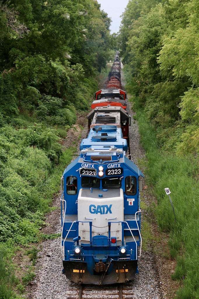 A friendly wave from the brakeman on 580 as the train crawls towards Brantford's east end and ducks under Wayne Gretzky Parkway. Up front are a pair of GP38's and a Dash-9, and pulling hard on the trailing units draw bar is a long cut of coil cars and tank cars destined for Nanticoke. The odd sounding horn on the lead unit I have named the "duct tape queen" is soon explained by the odd 2 chime horn apparently missing a chime. It's also nice to see this train running again after another stand off period in Caledonia.