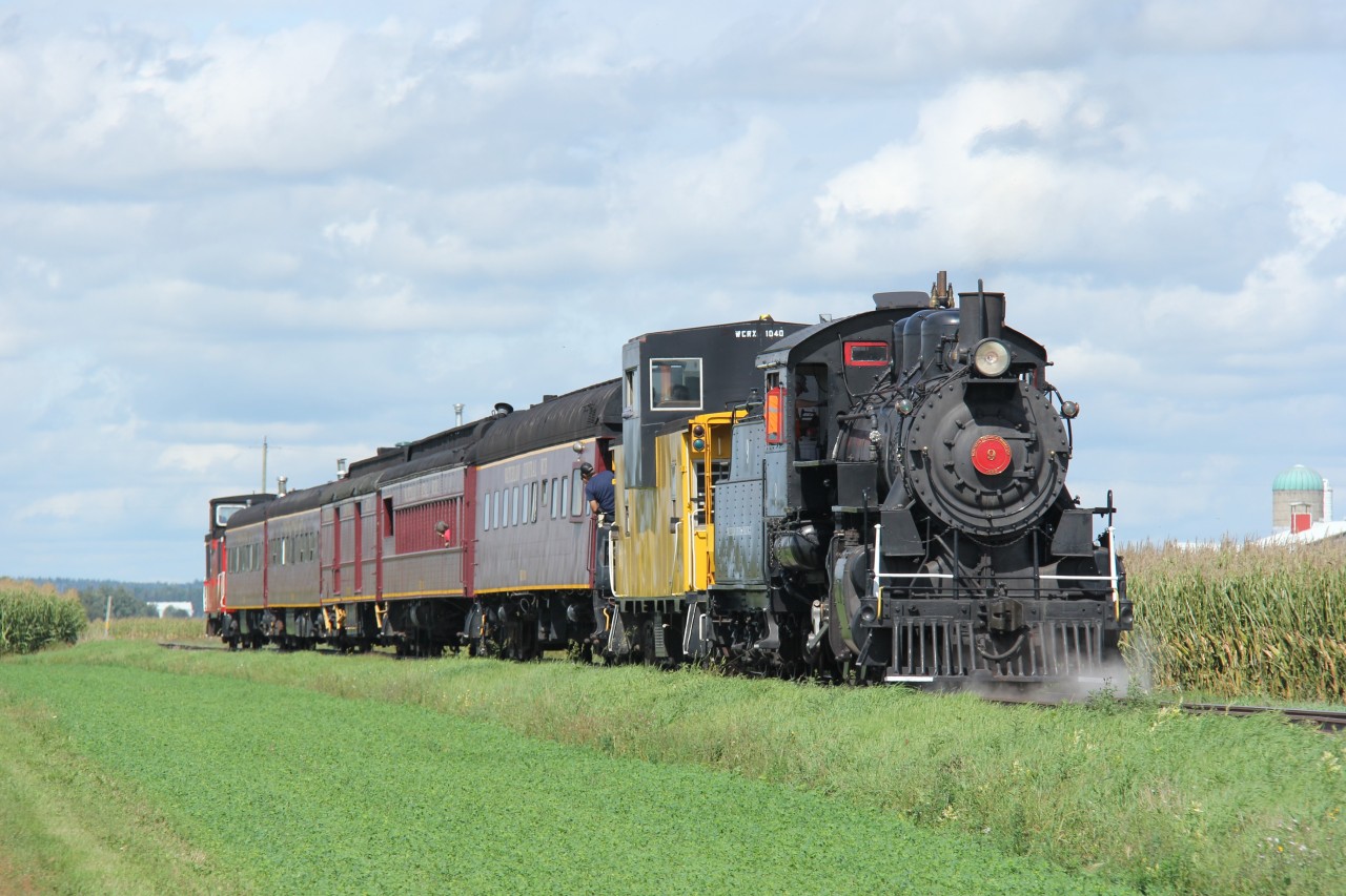 Surrounded by farms and cornfields between St. Jacobs and Elmira, the Labour Day Waterloo Central Railway (WCR) special with Engine No. 9 prepares for a photo run-by. A fun day out with family and friends!