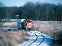 In 1997 Canadian Pacific had advised it's intention of no longer operating the Guelph Junction Railway due to continued declining traffic volumes and issued their notice of discontinuance on the Goderich Subdivision at the end of 1997. This left the city of Guelph with having no choice but to find a new operator for the following year. 
<br>
The last day of 1997 was sunny however it was extremely cold. If polar vortex's would have existed then that day could have been one on it's own. However the weather didn't stop history from happening as the CP Guelph local went about its regular duties. The job switched around Guelph Jct. then made a run over to Puslinch to service the customer there before returning to Guelph Jct. After some additional work the crew lifted one hopper car for Owens Corning. There CP GP9u 1614 departed for the final time for Guelph during the mid-afternoon. 
<br>
Here northbound 1614 is seen approaching Concession 11 at "Danger Bell Crossing" in Puslinch Township as it slowly made its way to Guelph. 