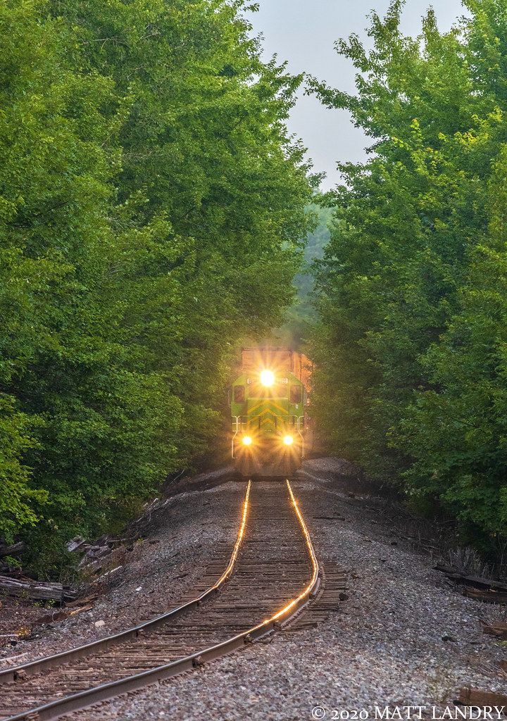 NBSR 6319 leads a Canadian Pacific stack train, as they approach Blissville, New Brunswick, heading along a nice cut of trees.