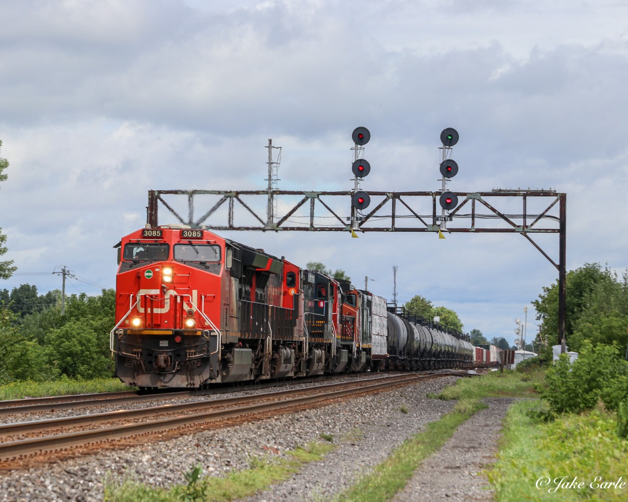 CN 369 ducking underneath an old signal tower by station sign Coteau. The last 3 units likely came out of storage at CN’s Taschereau yard in St Lambert QC, as they were offline and cause those units haven’t been out for some time.