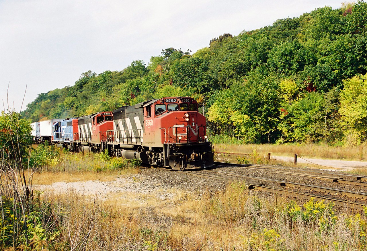 CN "Laser Train" 238 descends the Niagara Escarpment grade with 9650, 9631 and GT 5929 during an early fall morning as it passes the location of the former Dundas station. While probably a few feet away from an exact "Time Machine" comparison it still shows the differences over 34 years later compared with Doug Page's great image at the same location. 

http://www.railpictures.ca/?attachment_id=42433