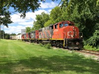 CN L568 with 4784, 7071 and 7083 is crossing Queen Street in Kitchener, Ontario on the Huron Park Spur as it heads to the interchange with Canadian Pacific. After working the spur, L568 would depart westbound for Stratford on the Guelph Subdivision. August 24, 2019.
