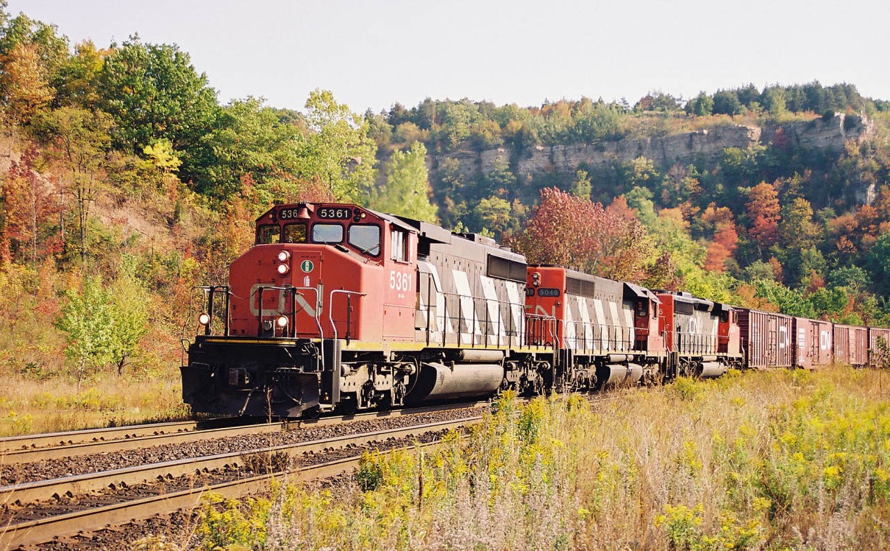 The fall colours were beginning to emerge as a mid-morning CN westbound powered by 5361, 5049 and 5356 dragged 93 cars up the Niagara Escarpment through Dundas on the appropriately named Dundas Subdivision. This photo was taken across from where the small station once stood under famed Dundas Peak.