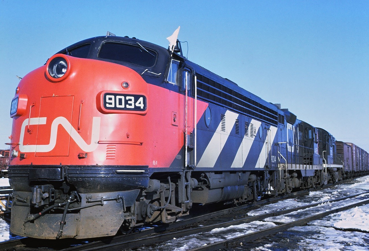 By April 1967, it was very rare to see a CN F7 east of Winnipeg.  Here 9034, leading train 301, takes on fuel at the west end of the Capreol Ontario station platform.   The other units are 4465 and 3733.  The first car appears to be an MDT reefer, possibly with potatoes from PEI.